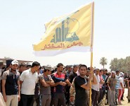 Shiite volunteers from Hezbollah Iraq, who have joined the Iraqi army to fight against militants of the Islamic State, formerly known as the Islamic State in Iraq and the Levant (ISIL), gather together in Baghdad