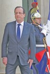 French President Francois Hollande stands on the steps of the Elysee Palace in Paris