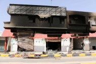 A damaged building of stores is pictured after a shelling in Qaser Bin Ghashir, near the Tripoli International Airport