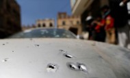 Damage is seen on a car after being hit by shrapnel from a mortar shell during fighting between Shi'ite Houthi rebels and government forces in Sanaa