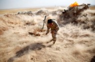 File photo of a Kurdish Peshmerga fighter launching mortar shells towards Zummar, controlled by Islamic State, near Mosul