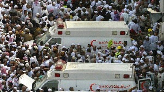 Muslim pilgrims gather near ambulances f