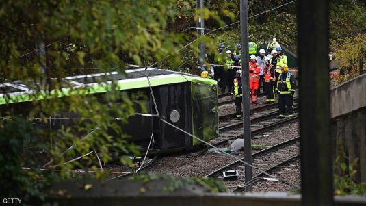 LONDON, ENGLAND - NOVEMBER 09: Members of London Fire Brigade look at the overturned tram at the site where two people are trapped after a tram derailed in a tunnel near Sandilands Tram stop in Croydon at 6.04am this morning on November 9, 2016 in London, England. A further 50 people have been injured. (Photo by Carl Court/Getty Images)