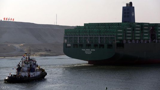 SUEZ, EGYPT - AUGUST 06:  An Evergreen boat flagged in Singapore passes through during the opening ceremony of the new Suez Canal expansion including a new 35km (22 mile) channel on August 6, 2015 in Suez, Egypt. The new channel of the Suez Canal was finished in a year at a cost of 8 billion USD and is designed to increase the speed and capacity of ships.  The new branch is being celebrated as a major nationalist project. (Photo by David Degner/Getty Images).