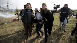TOPSHOTS Palestinian carry a fellow prot