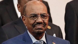 Sudan's President Bashir prepares for a group photograph ahead of the African Union summit in Johannesburg