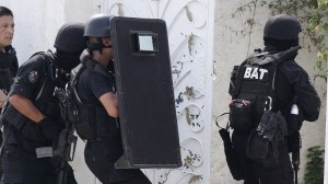 Tunisian anti-terrorism brigade personnel take position after a shooting at the Bouchoucha military base in Tunis