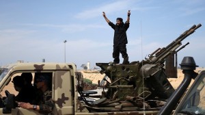 A fighter from Misrata shouts to his comrades as they move to fight Islamic State militants near Sirte