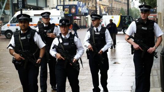 British armed police patrol London's Leicester Square in July 2005, following the suicide bombings on the London transport system. The photo,  widely published, was transmitted into the Associated Press World wide network directly from a pda using Phojo, from a nearby wifi point.This copy was sent into the Idruna FTP, via Phojo, at the same compression as the original transmission.photo by max nash