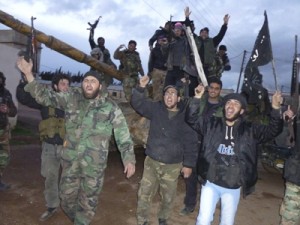 Free Syrian Army fighters carry their weapons as they cheer in Qusair town near Homs