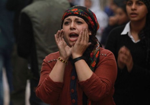 A Kurdish woman shouts slogans during a demonstration against Islamic State insurgent attacks on the Syrian Kurdish town of Kobani, in Sheikh Maksoud neighborhood of Aleppo