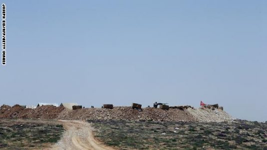 Hezbollah fighters monitor the countryside of Arsal from their post in Dahr al-Hawa hill on the Lebanese side of the Qalamun mountains on the border with Syria on May 20, 2015. Ali Akbar Velayati, foreign affairs adviser to supreme leader Ayatollah Ali Khamenei, said on May 18 during a trip to Beirut, that Tehran was proud of its key ally Hezbollah for advances it has made against rebels in a Syrian region on the Lebanese border. AFP PHOTO / JOSEPH EID        (Photo credit should read JOSEPH EID/AFP/Getty Images)